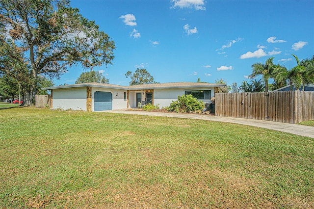 single story home with a front yard and a garage