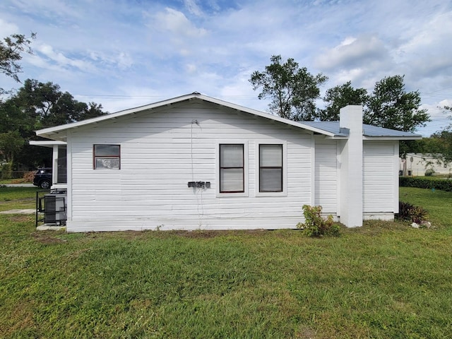 view of side of home featuring a yard