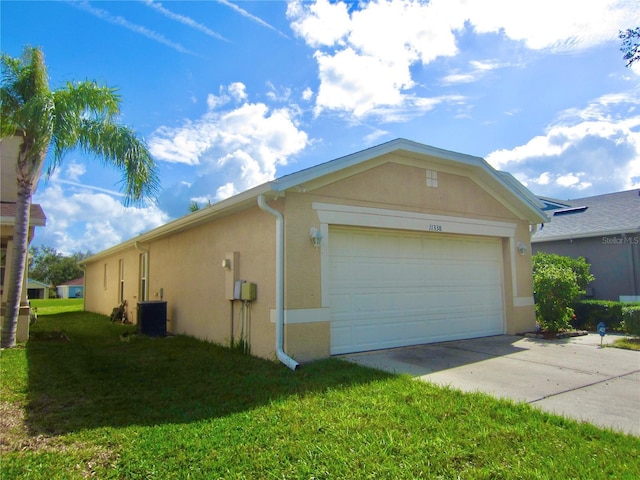 exterior space with a lawn, a garage, and central air condition unit