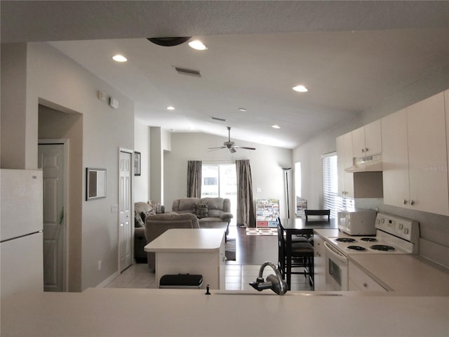 kitchen with white cabinetry, ceiling fan, vaulted ceiling, white appliances, and light tile patterned flooring