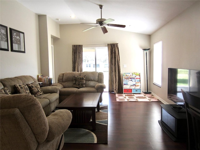 living room with ceiling fan, dark wood-type flooring, and lofted ceiling