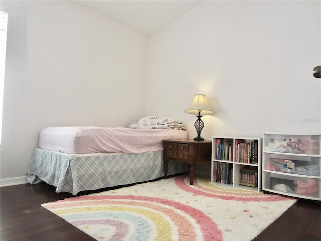 bedroom featuring hardwood / wood-style floors and lofted ceiling