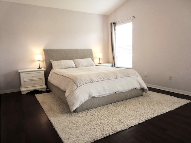 bedroom featuring dark hardwood / wood-style floors and lofted ceiling