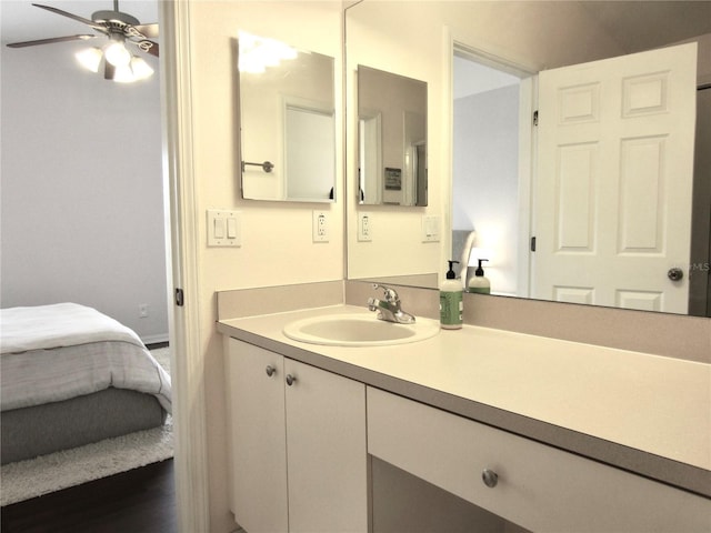 bathroom featuring ceiling fan, wood-type flooring, and vanity