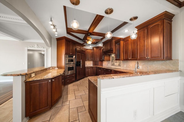 kitchen featuring kitchen peninsula, ceiling fan, decorative light fixtures, beam ceiling, and decorative backsplash