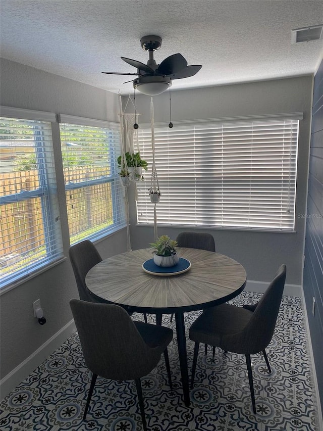 dining room featuring a textured ceiling and ceiling fan