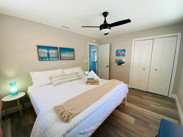 bedroom with dark hardwood / wood-style floors, a closet, and ceiling fan