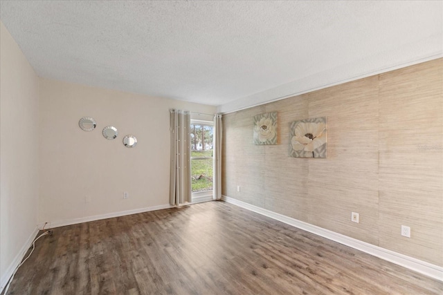 unfurnished room with a textured ceiling and hardwood / wood-style flooring