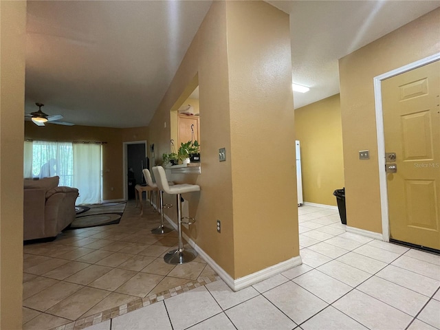 tiled entrance foyer with ceiling fan