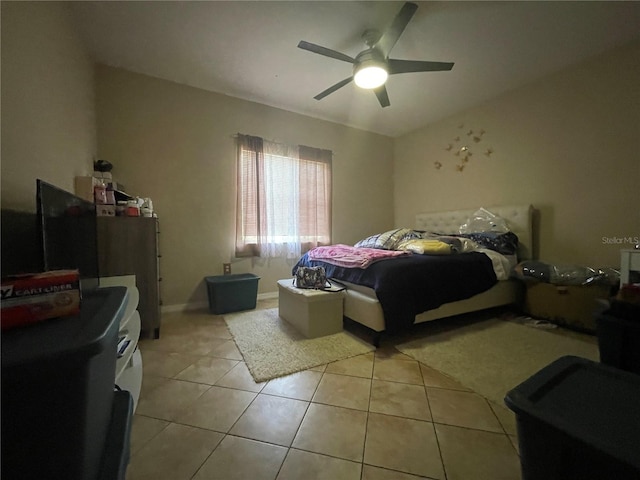 tiled bedroom featuring ceiling fan