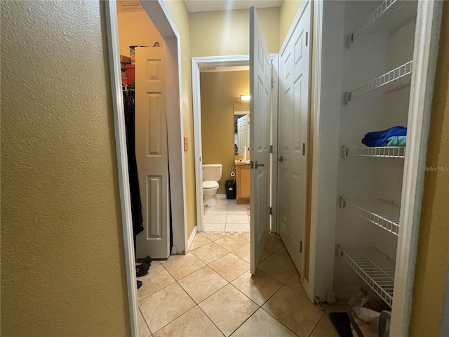 hall featuring light tile patterned floors