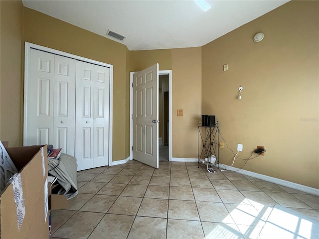 interior space featuring a closet and light tile patterned floors