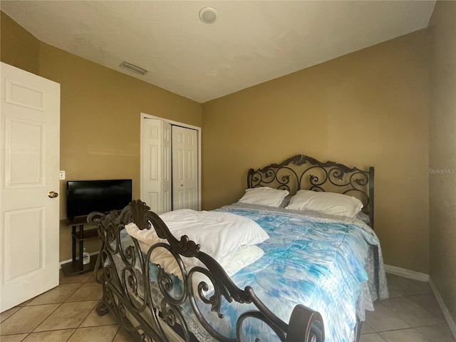 bedroom featuring a closet and light tile patterned floors