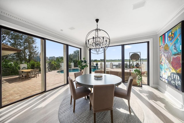 sunroom / solarium with an inviting chandelier