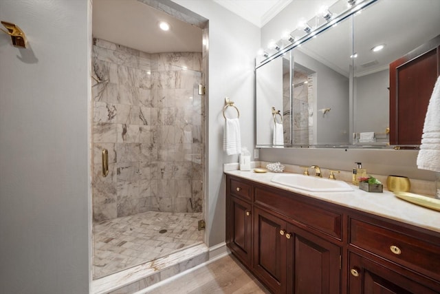 full bath with ornamental molding, recessed lighting, vanity, and a shower stall