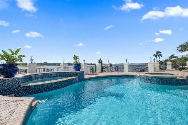 view of pool with an in ground hot tub, fence, and a fenced in pool