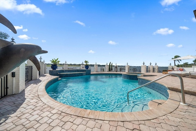 view of swimming pool featuring a patio, fence, and a pool with connected hot tub