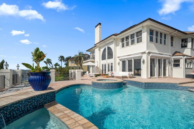 view of swimming pool featuring a patio, outdoor lounge area, fence, and a pool with connected hot tub