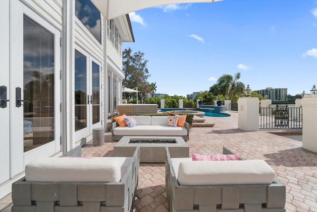 view of patio / terrace with an outdoor living space with a fire pit, a fenced in pool, and fence