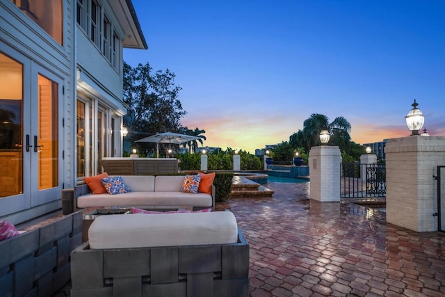 view of patio with french doors, an outdoor living space, and a fenced in pool