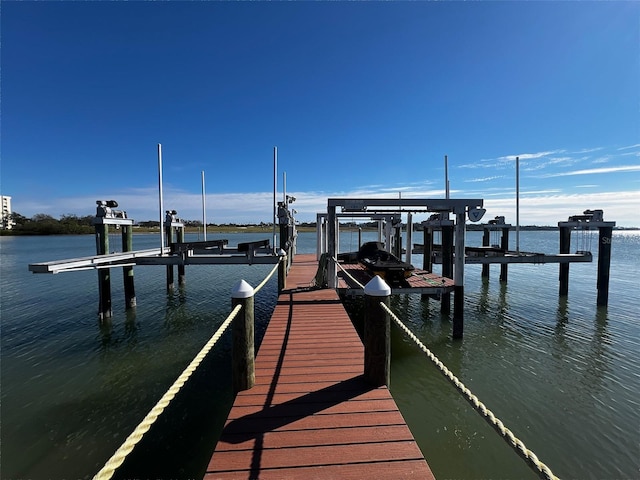 dock area with a water view and boat lift