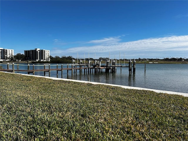 dock area featuring a water view and a lawn