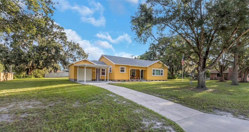 ranch-style house with a garage and a front lawn