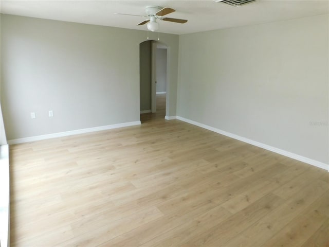 empty room featuring ceiling fan and light wood-type flooring