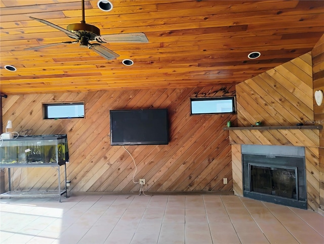 unfurnished living room with ceiling fan, wooden walls, and wooden ceiling