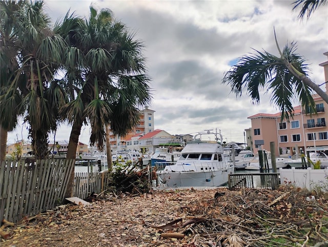 view of yard featuring a water view and a dock