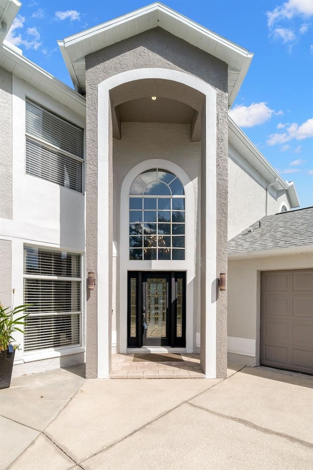 view of exterior entry featuring a garage