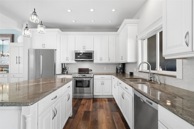 kitchen with white cabinetry, appliances with stainless steel finishes, sink, and hanging light fixtures