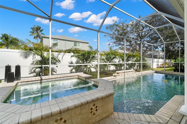 view of swimming pool featuring a lanai and an in ground hot tub