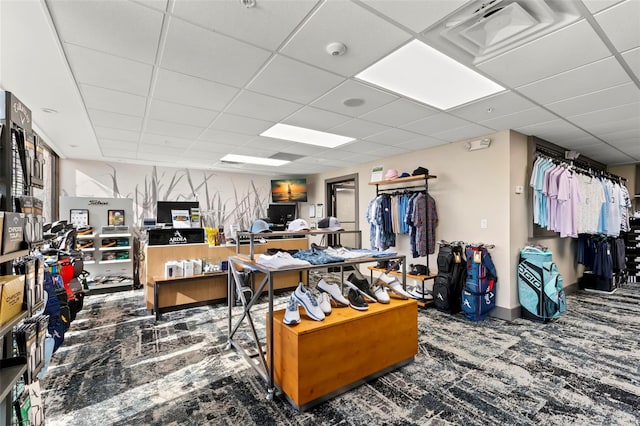 miscellaneous room featuring a drop ceiling and carpet flooring