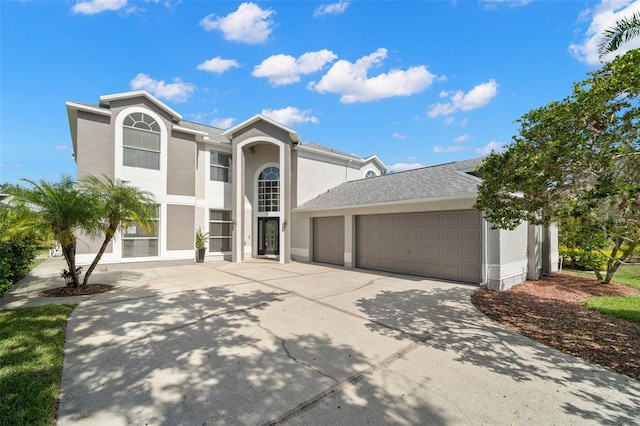 view of front of property featuring stucco siding, driveway, and an attached garage