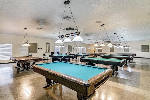 game room with a textured ceiling and pool table