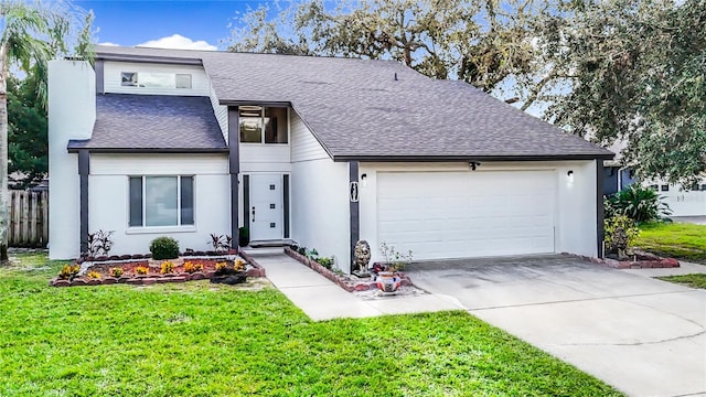 view of front of property featuring a front yard and a garage