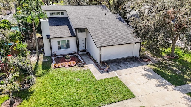 view of front of home with a front yard and a garage