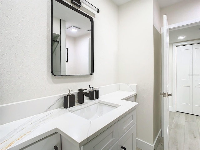 bathroom featuring vanity and hardwood / wood-style flooring