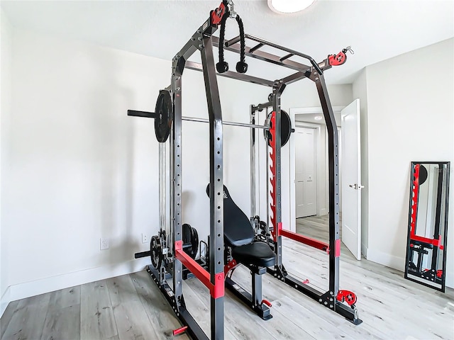 workout room with light hardwood / wood-style flooring