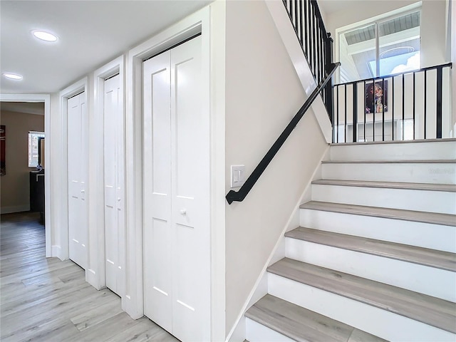 stairs featuring hardwood / wood-style floors