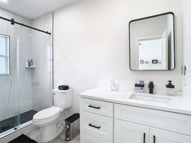 bathroom featuring vanity, toilet, and walk in shower