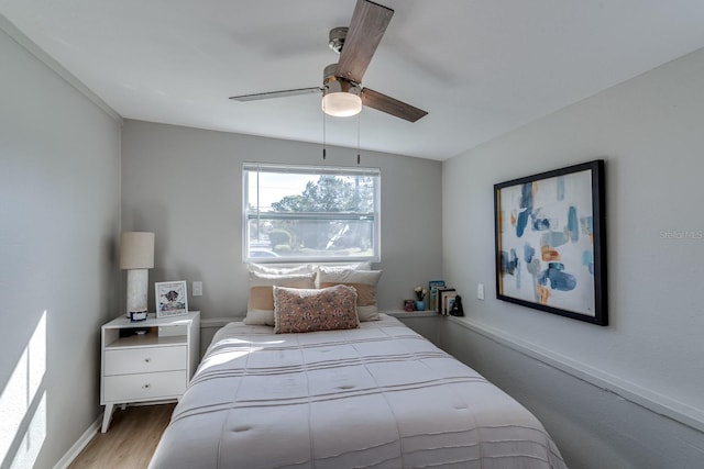 bedroom with ceiling fan and hardwood / wood-style flooring