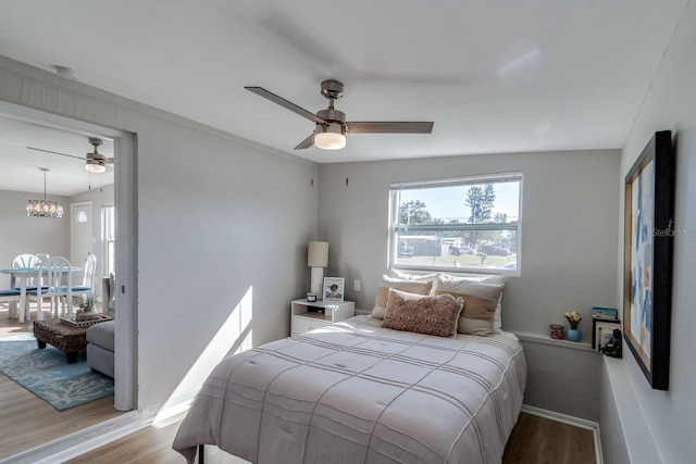 bedroom with ceiling fan and light hardwood / wood-style floors