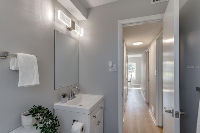 bathroom featuring hardwood / wood-style floors and vanity