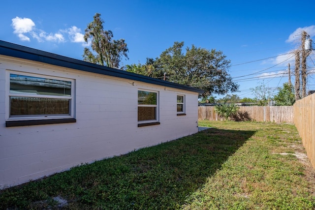 view of property exterior with a lawn