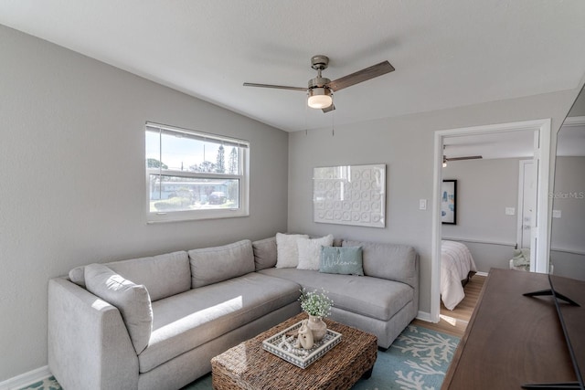 living room featuring wood-type flooring and ceiling fan