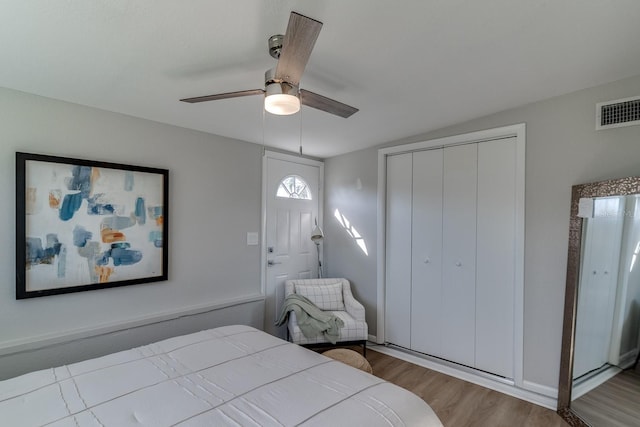 bedroom with a closet, ceiling fan, and light hardwood / wood-style flooring