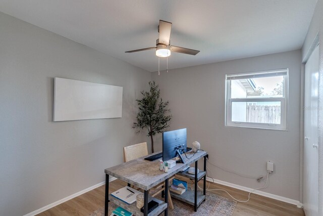 office space with hardwood / wood-style floors and ceiling fan