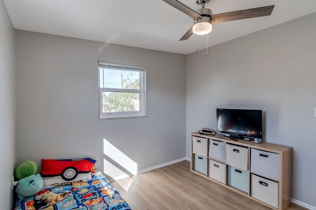 bedroom with ceiling fan and light hardwood / wood-style floors